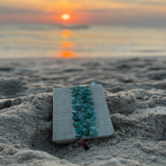 Liniertes Notizbuch mit echten Aventurin-Steinen, energetisiert mit REIKI-Energie; fördert Intuition, Schutz, Klarheit und Selbstvertrauen. Jedes Notizbuch ist einzigartig durch individuelle Steinmuster und spirituelle Aufladung.